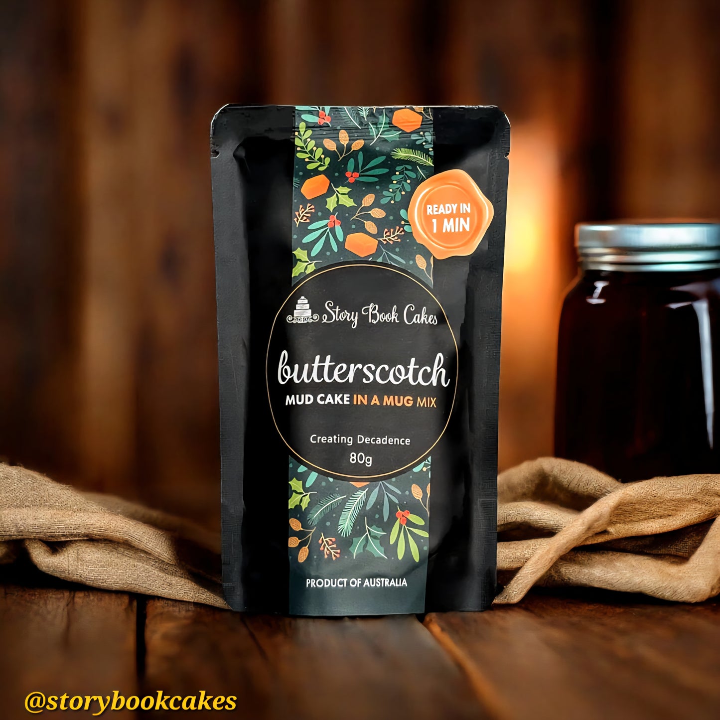 Butterscotch mud cake in a mug mix package with decorative label on a wooden surface.