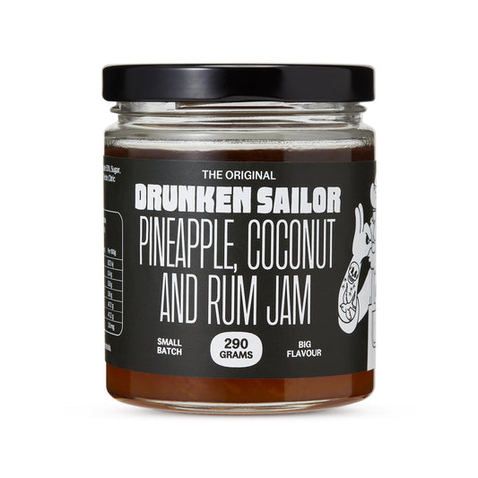 Jar of 'Drunken Sailor' pineapple, coconut, and rum jam on a white background
