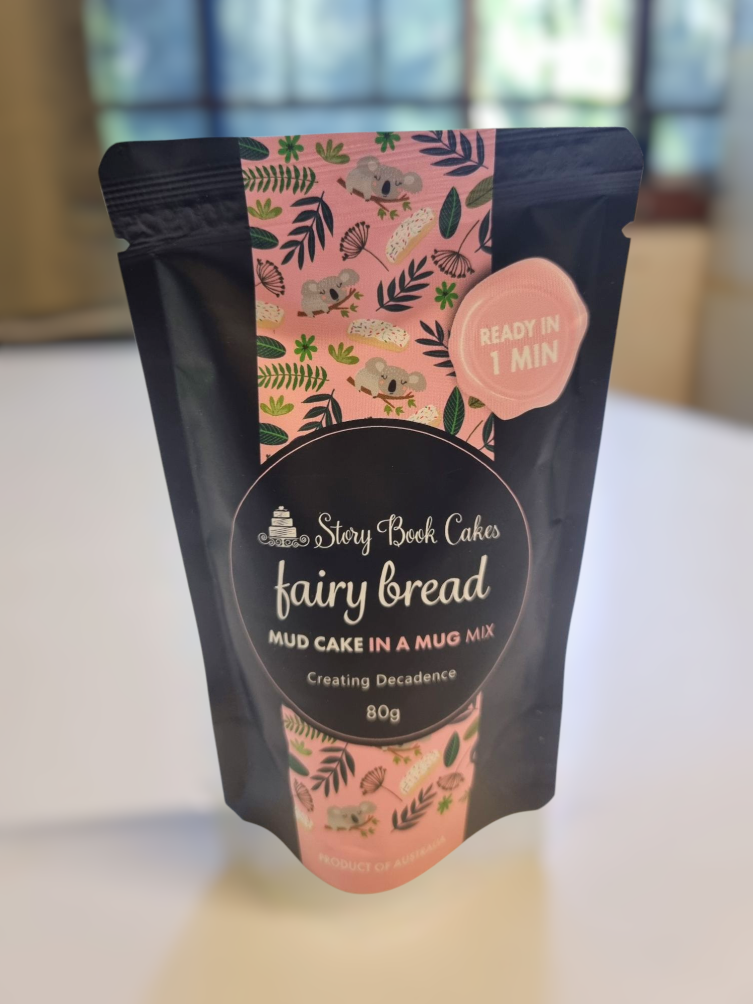 Package of fairy bread mix with pink and black design on a light background