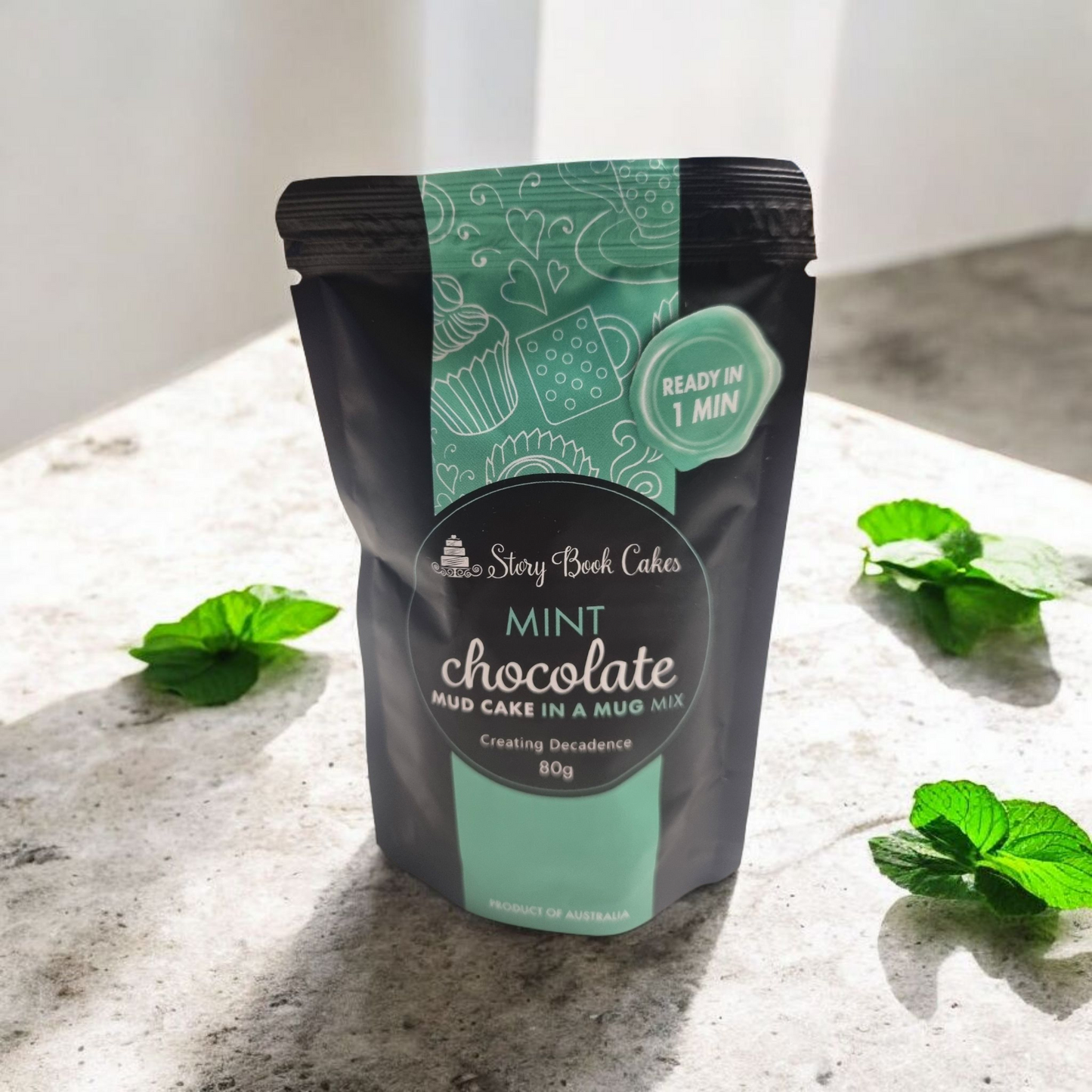 Mint chocolate mud cake mix package on a light surface with mint leaves