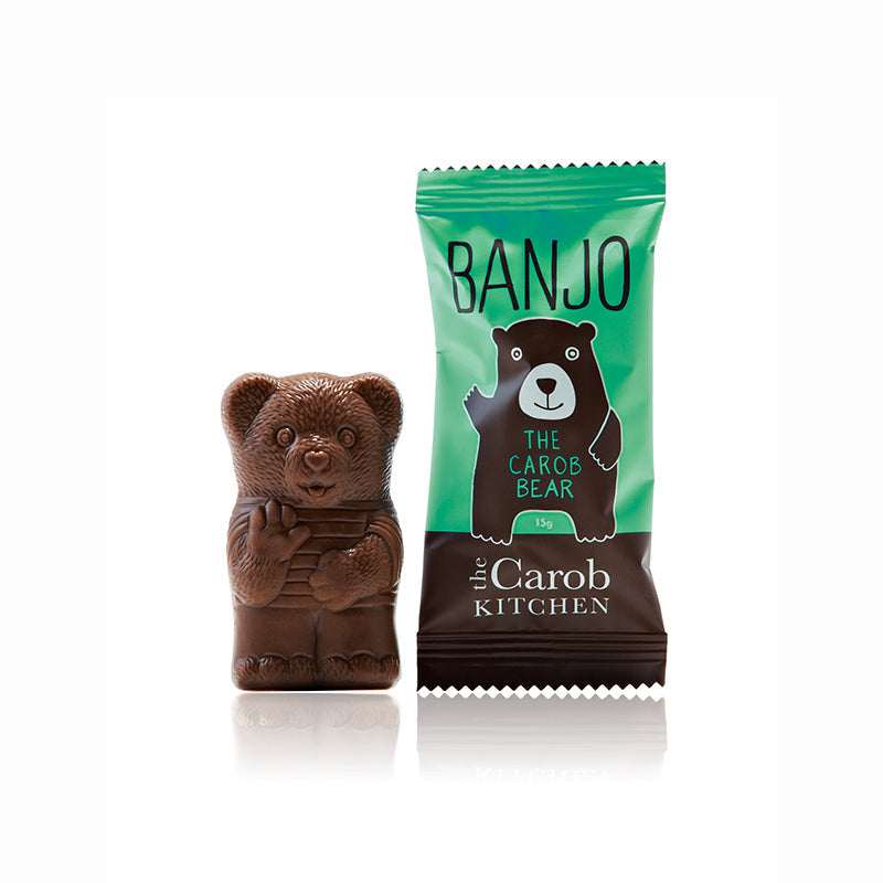 Carob Banjo bear figurine next to its packaging on a white background