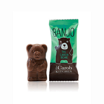 Carob Banjo bear figurine next to its packaging on a white background
