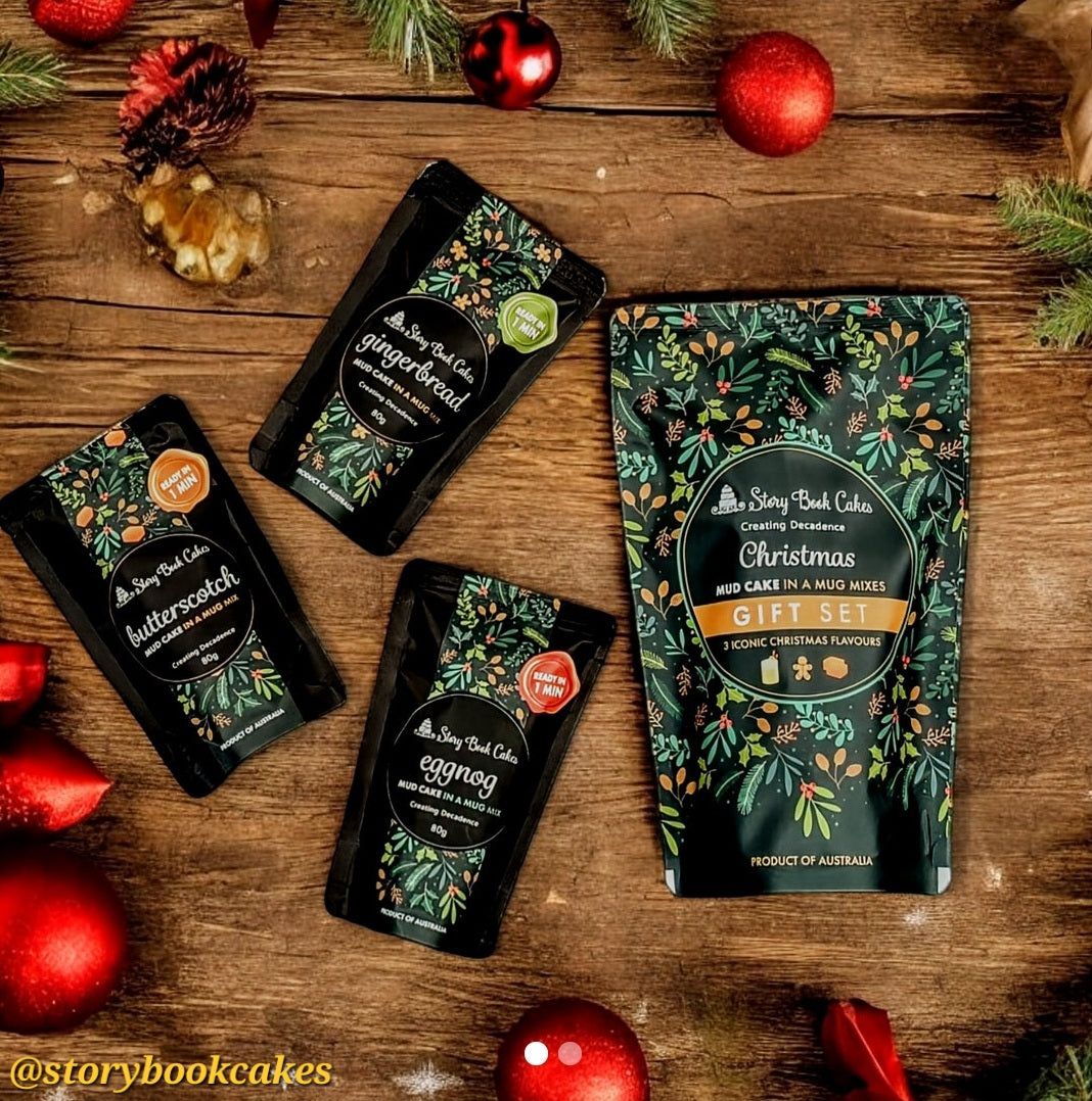 Storybook Cakes Christmas gift set on a wooden surface with festive decorations.