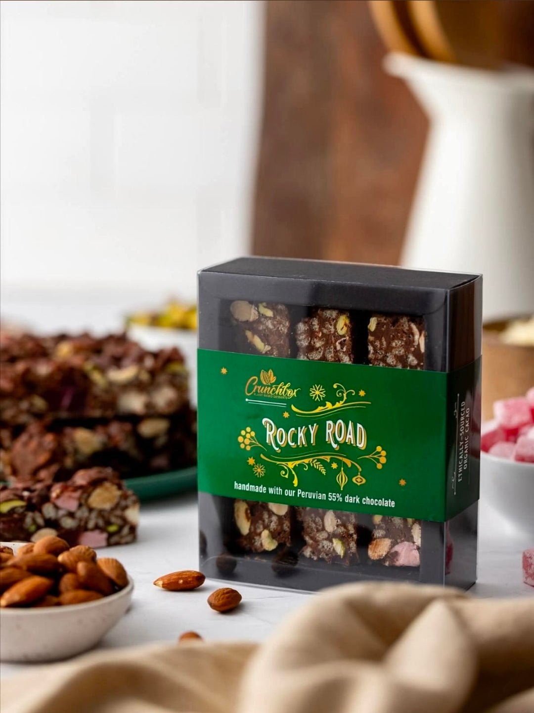 Gift Box of Crunchbox Traditional Rocky Road Pieces on a table with Rocky Road on it