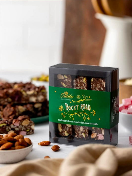 Gift Box of Crunchbox Traditional Rocky Road Pieces on a table with Rocky Road on it